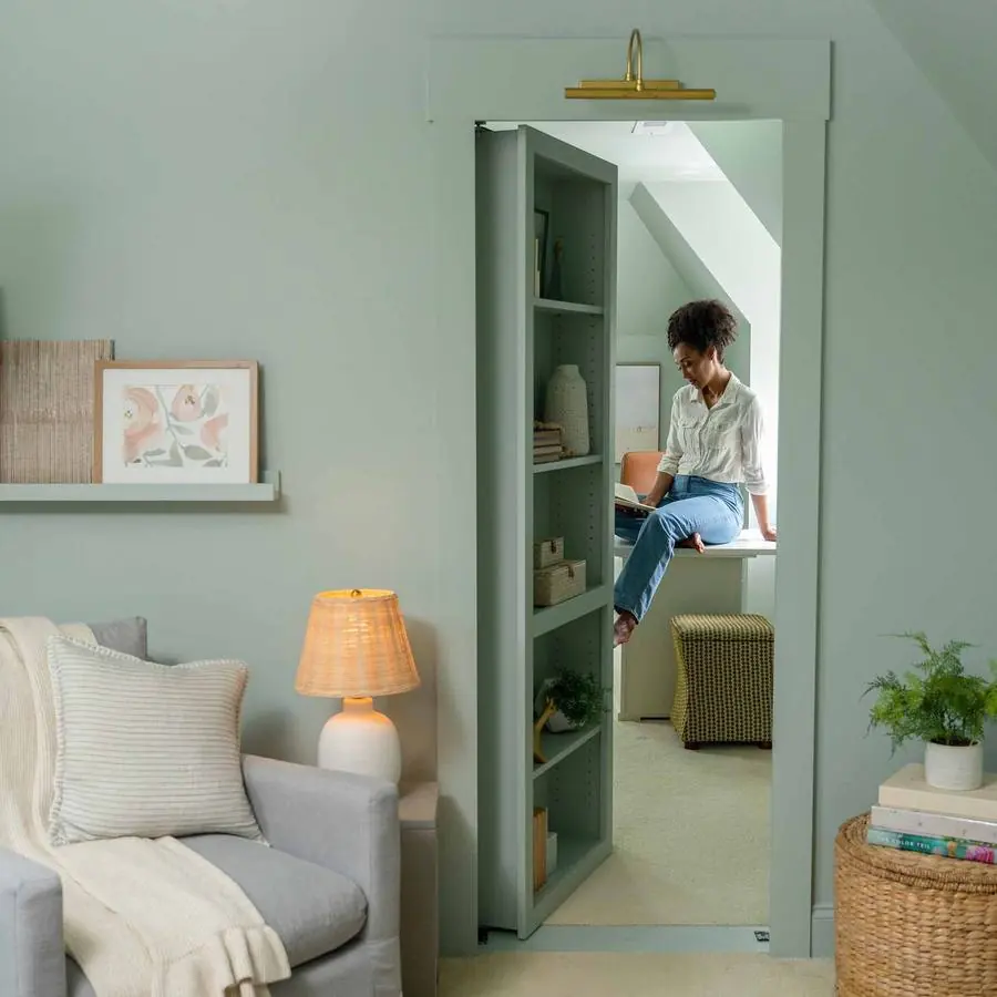 A Murphy Door® hidden bookcase door shown open, revealing the storage space behind it. Photo from murphydoor.com.