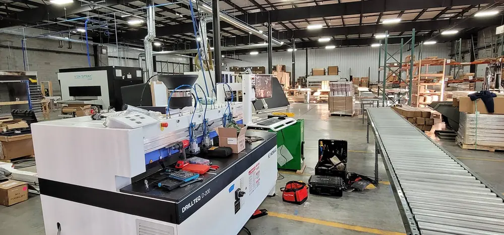 The Ven Spray One finish line and a Homag Drillteq D-200 drilling and dowel-insertion machine on the production floor. Photo provided by Jeremy Barker.