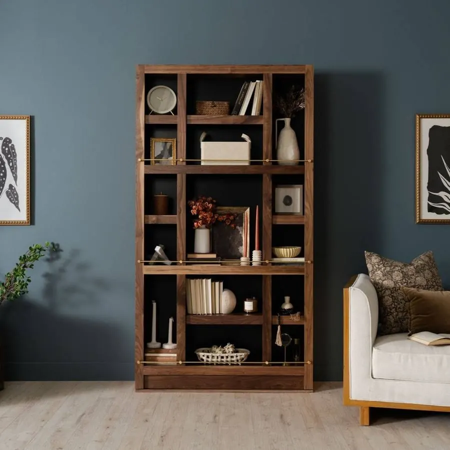 A walnut-finish hidden bookcase door against a blue-gray wall, showing the wood grain. Photo from murphydoor.com.