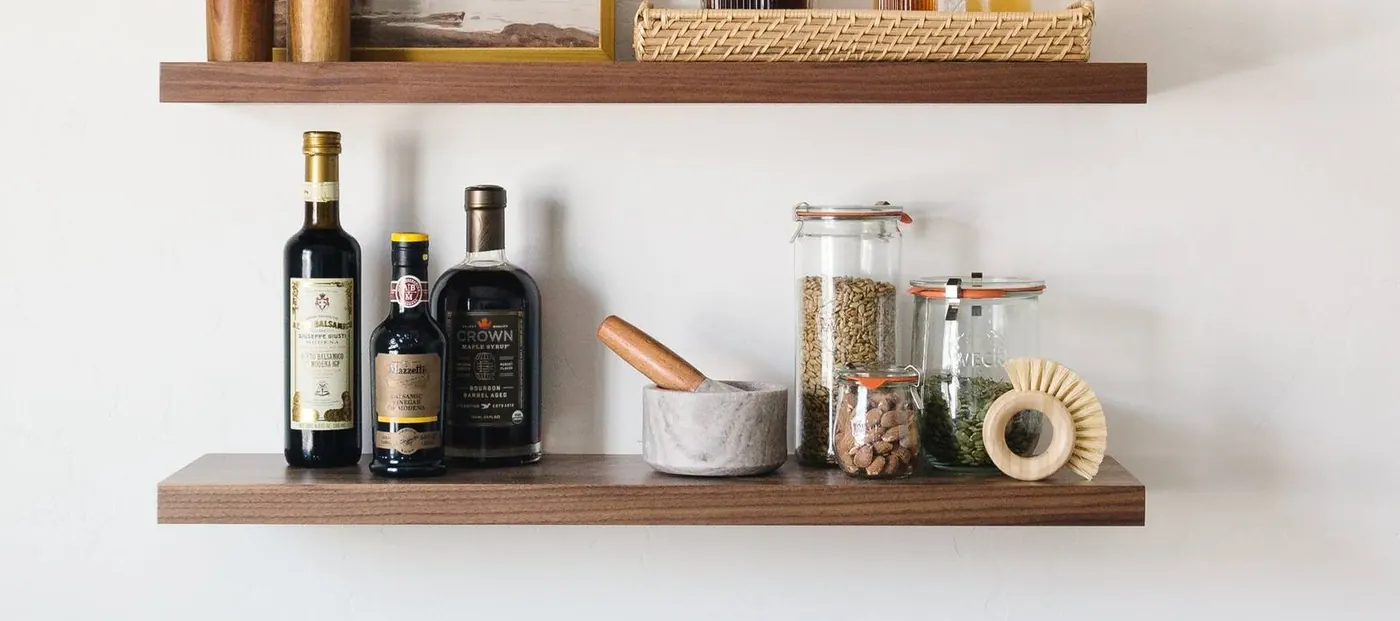 Walnut floating shelves styled with real bar and pantry goods, milled at the Rigby, Idaho facility. Photo from ultrashelf.com.